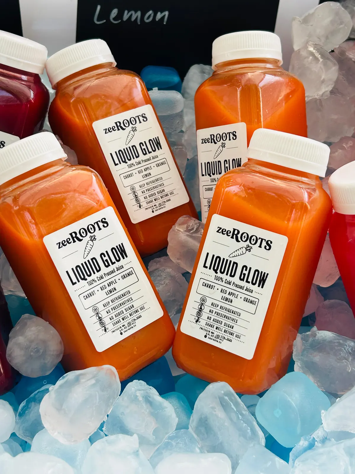 zeeROOTS market table with bottled cold-pressed juices