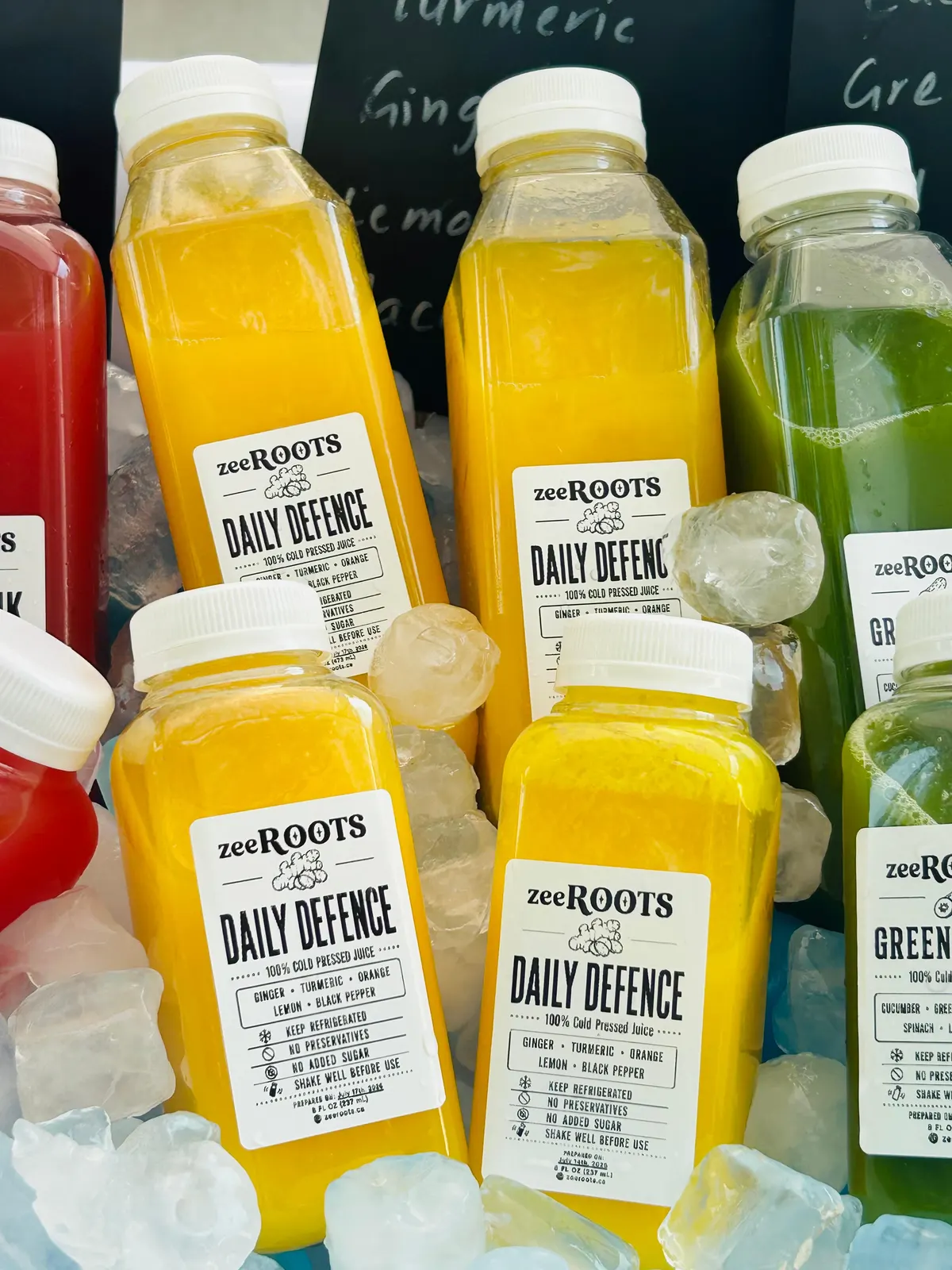 Fresh zeeROOTS juice bottles displayed for market shoppers